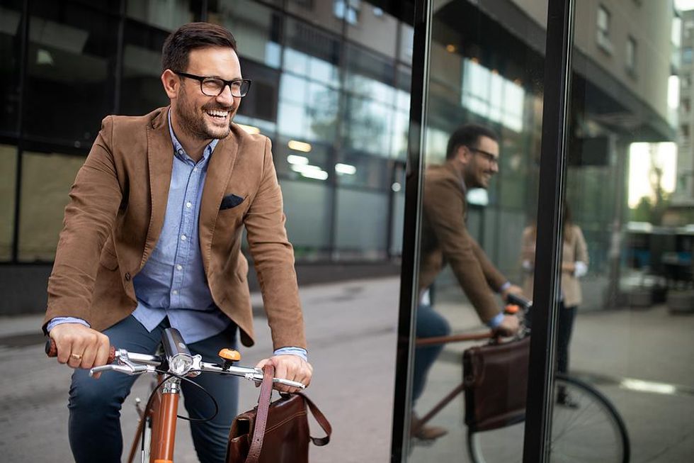 Professional man bikes to work in the summer