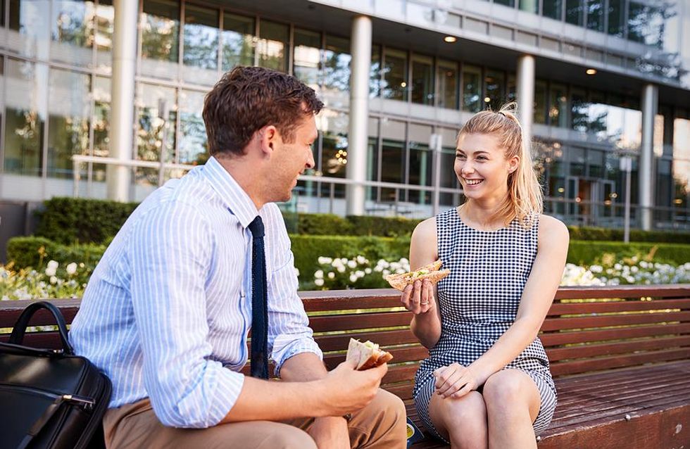 Coworkers eat lunch outside during the summer