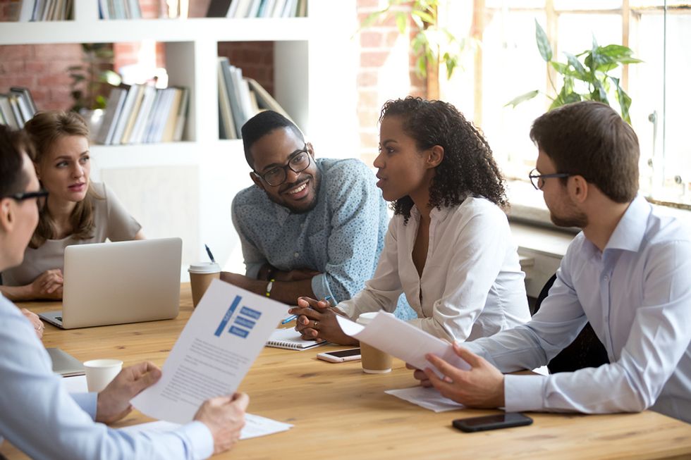 Group of loyal employees working together during a team meeting