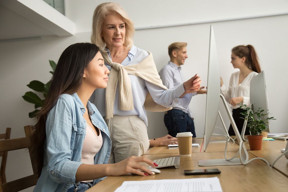 Senior employee trains a new employee to help her grow in her career