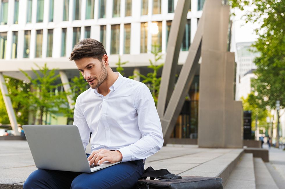 Professional man on laptop adds technical skills to his resume instead of fluff