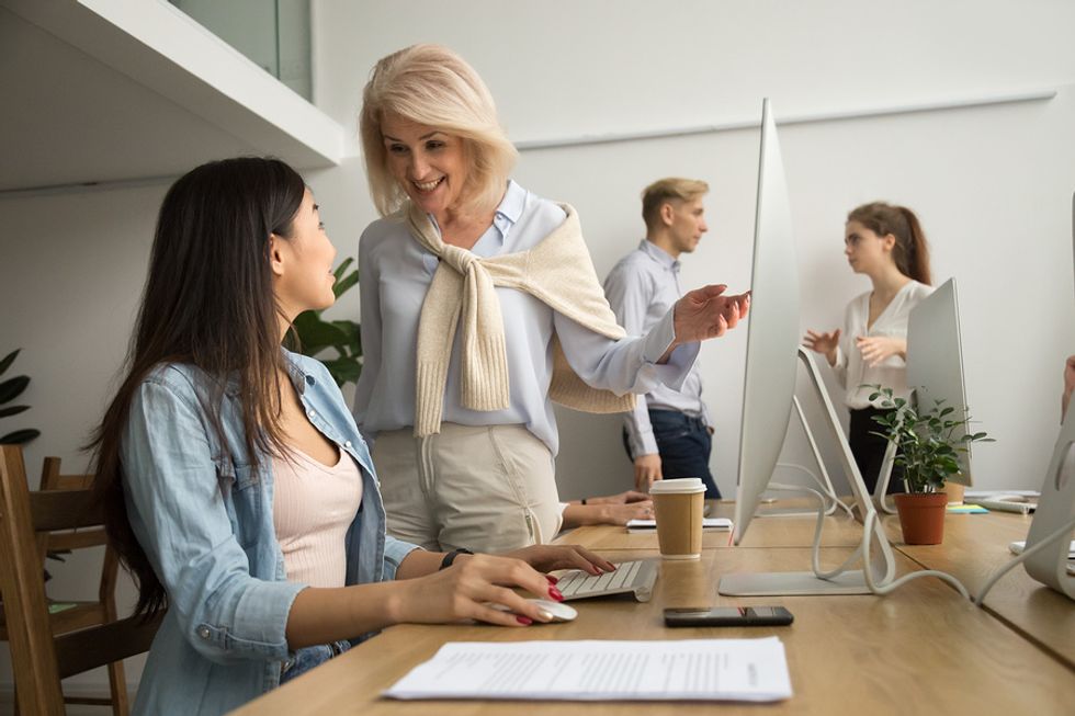 Woman smiles at a difficult co-worker at work