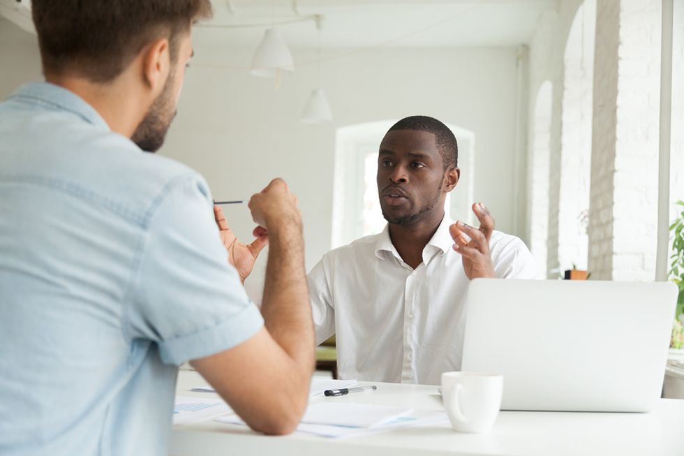 Professional man deals with a difficult co-worker during a meeting