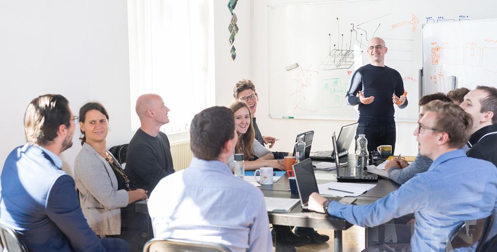 Man uses his leadership skills during work meeting/presentation