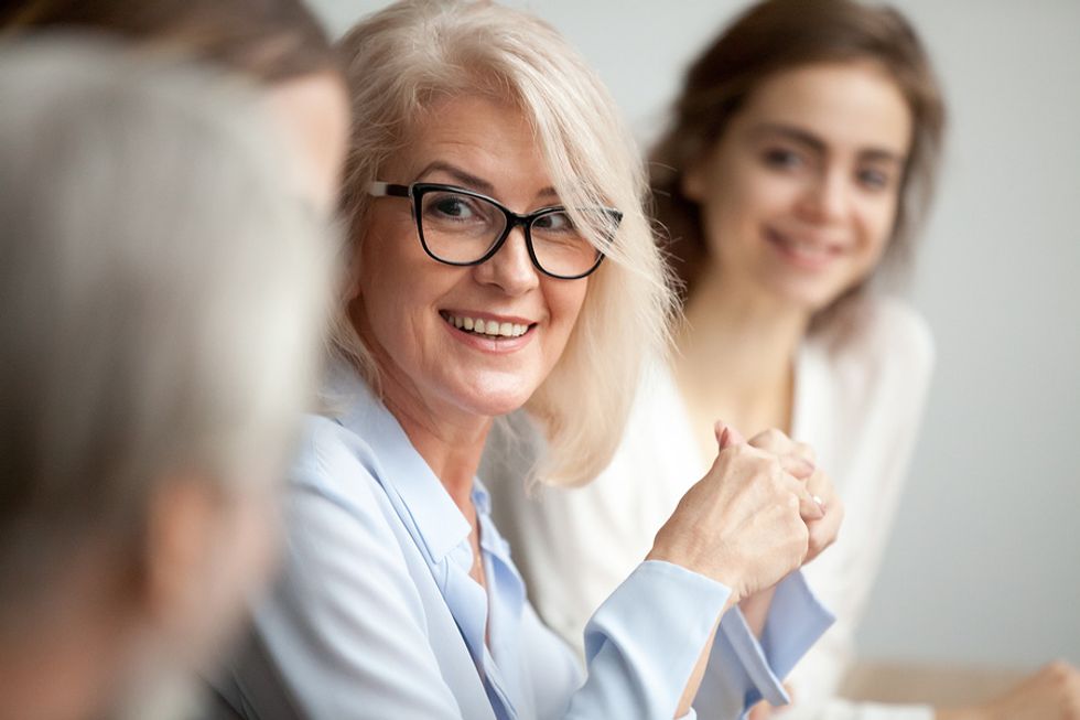 Female boss displaying her leadership skills at the office while talking to an employee