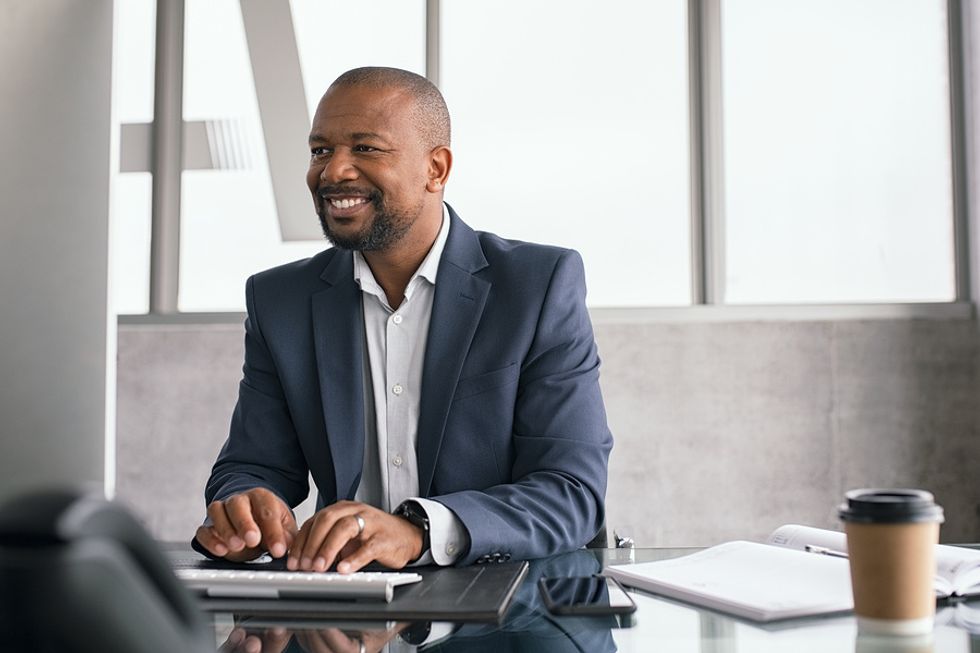 Professional man on computer finds career success after developing a key skill