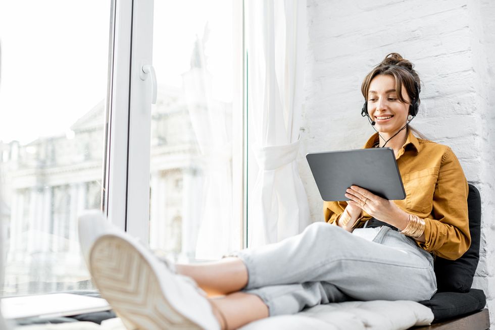 Young professional takes part in an online networking event while on summer vacation