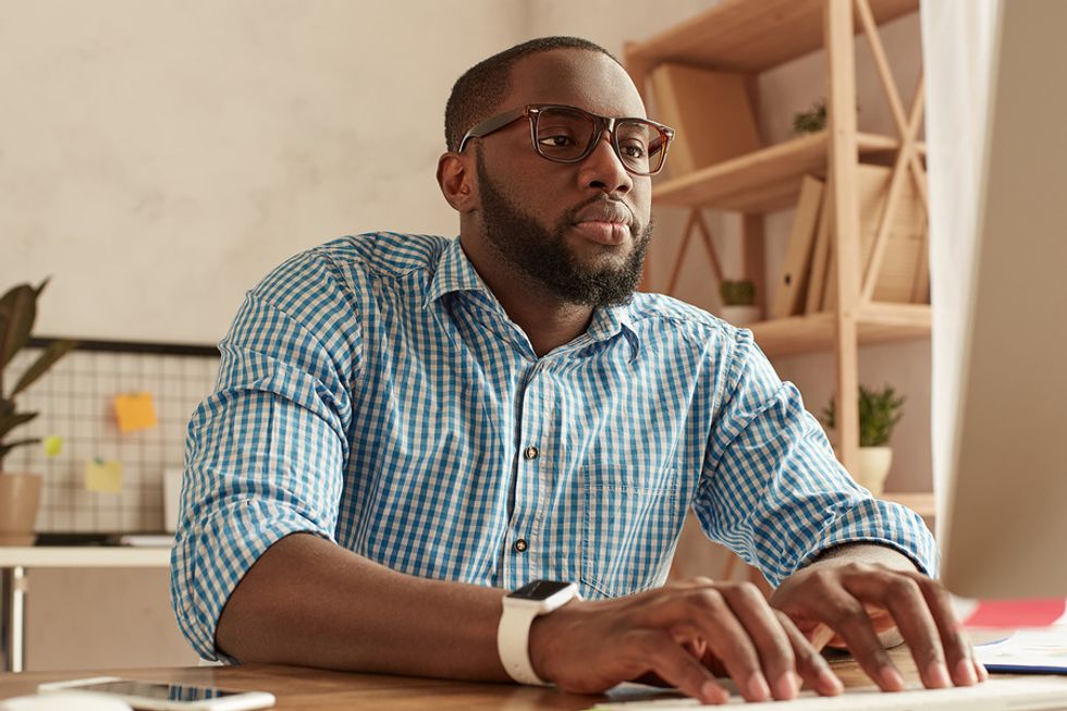 Man on laptop explores job opportunities after being laid off