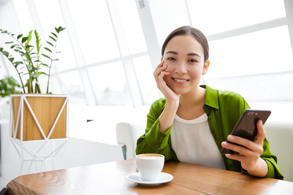 Woman on phone stays positive after being laid off