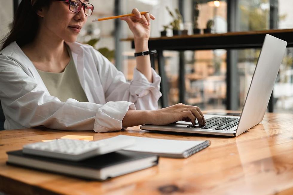 Recruiter on laptop researches a company in an industry she's unfamiliar with