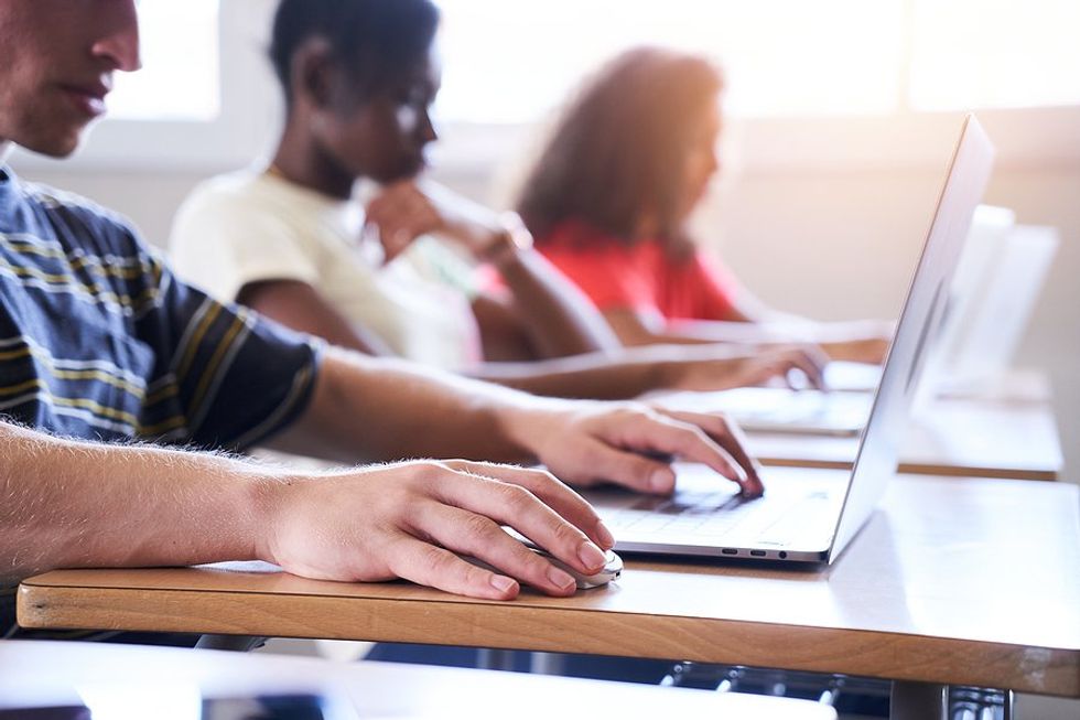 Students in a classroom with laptops take advantage of EdTech