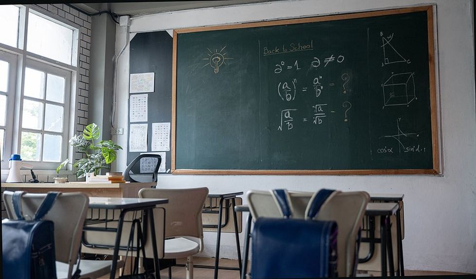 Empty classroom with math written on the chalkboard