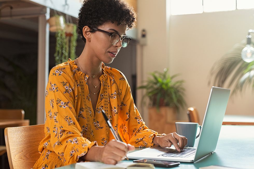 Woman writes down her skills while looking for a job