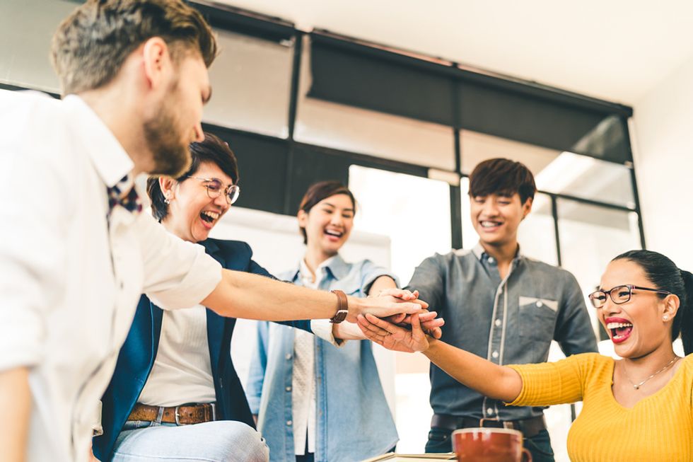 Happy coworkers connecting and working together as a team