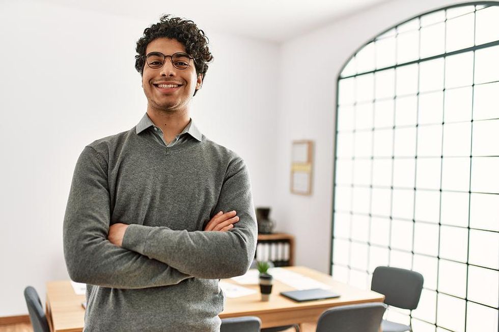 Happy man at work adopts a growth mindset