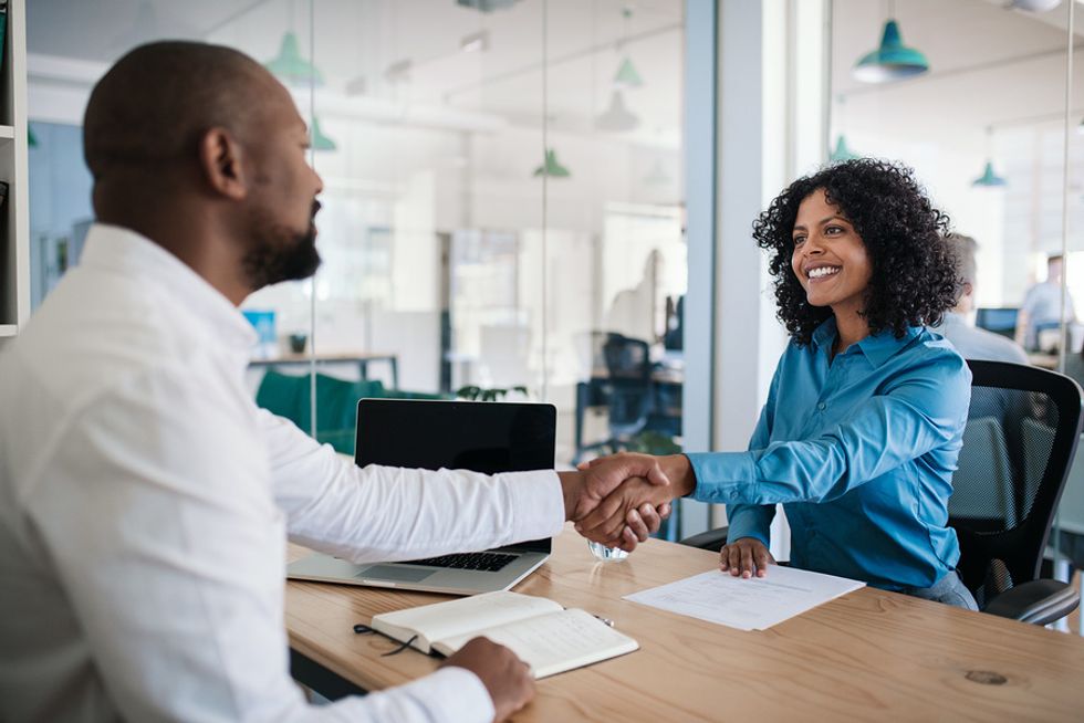 Hiring manager shakes hands with a job candidate that didn't appear overconfident in a job interview