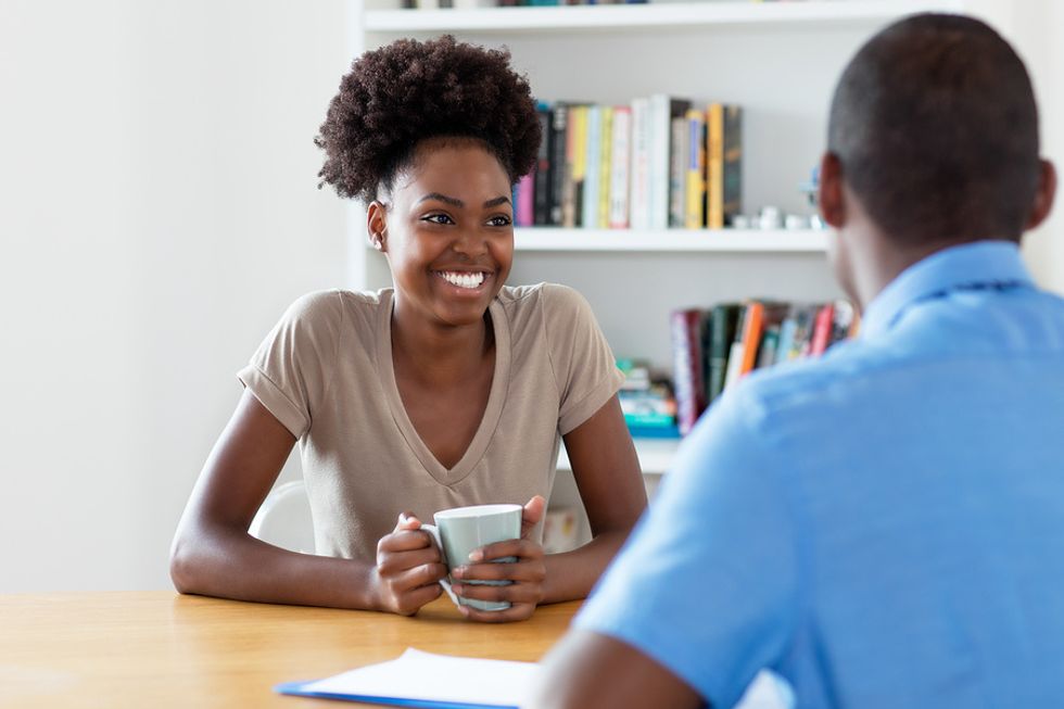 A woman helps her friend by doing a mock interview