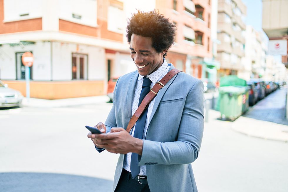 Man on phone follows up with employers during his job search by sending a thank-you note