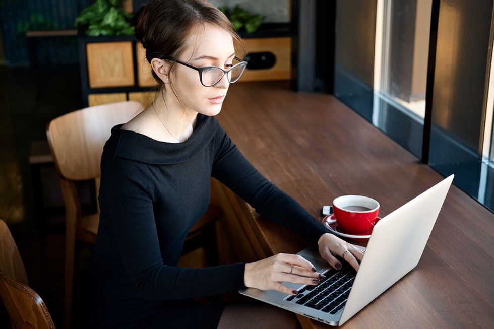 Woman writes a follow-up thank-you note after a job interview