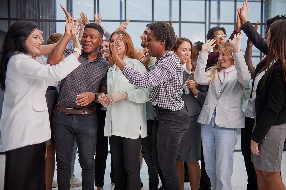 Happy employees/professionals celebrate at work