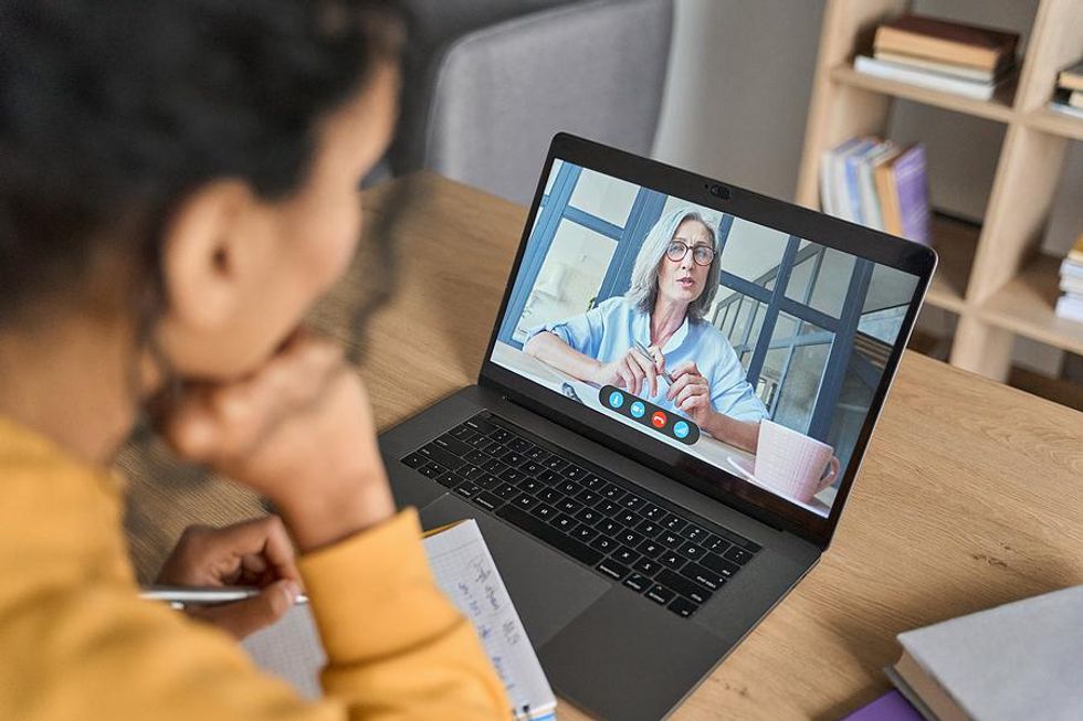 Virtual leader talks to her employees during a work meeting