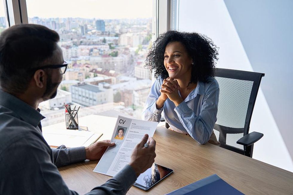 Interesting woman smiles and listens during a job interview