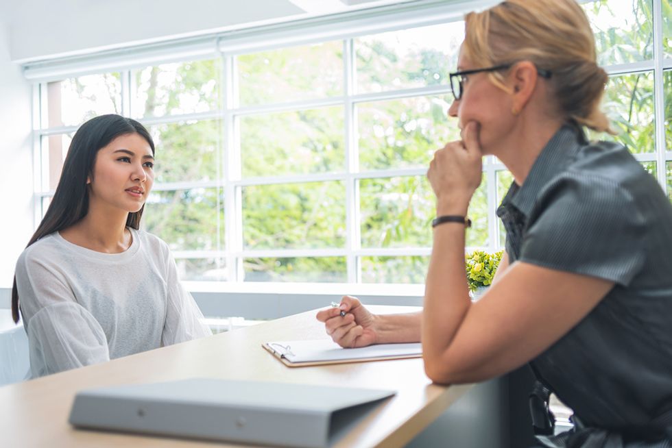 Young woman listens attentively during a job interview