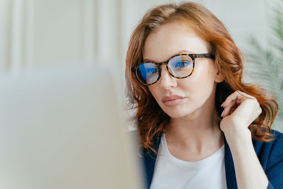 Confident young professional on laptop brainstorms some professional goals