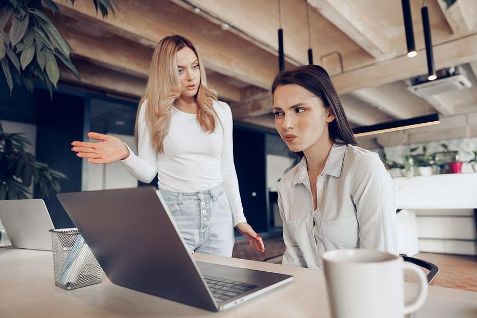 Woman listens to a horrible coworker without trying to resolve the conflict