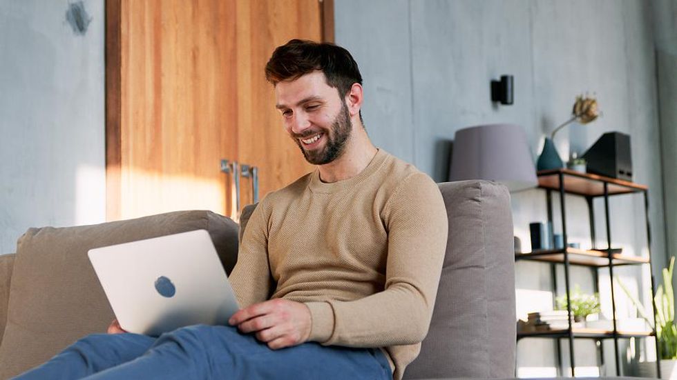 Man on laptop fixes his social media accounts while looking for a job