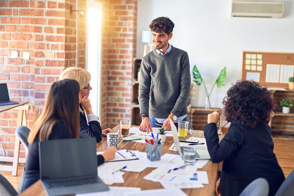 Man presenting to his colleagues at during a work meeting