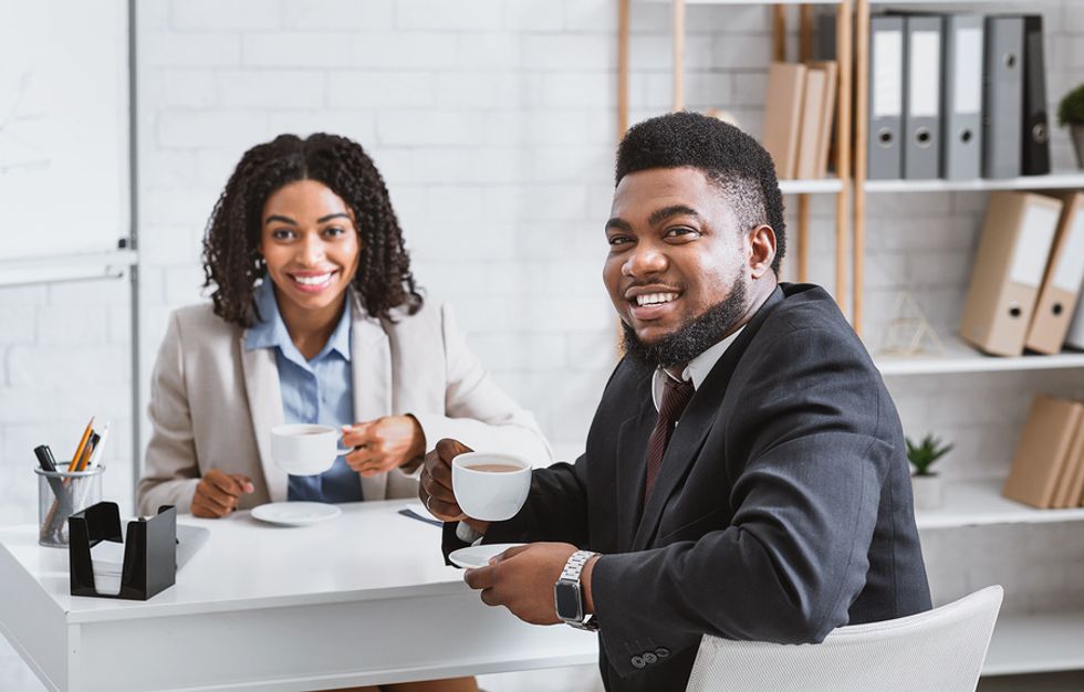 Two colleagues smile after a mock interview