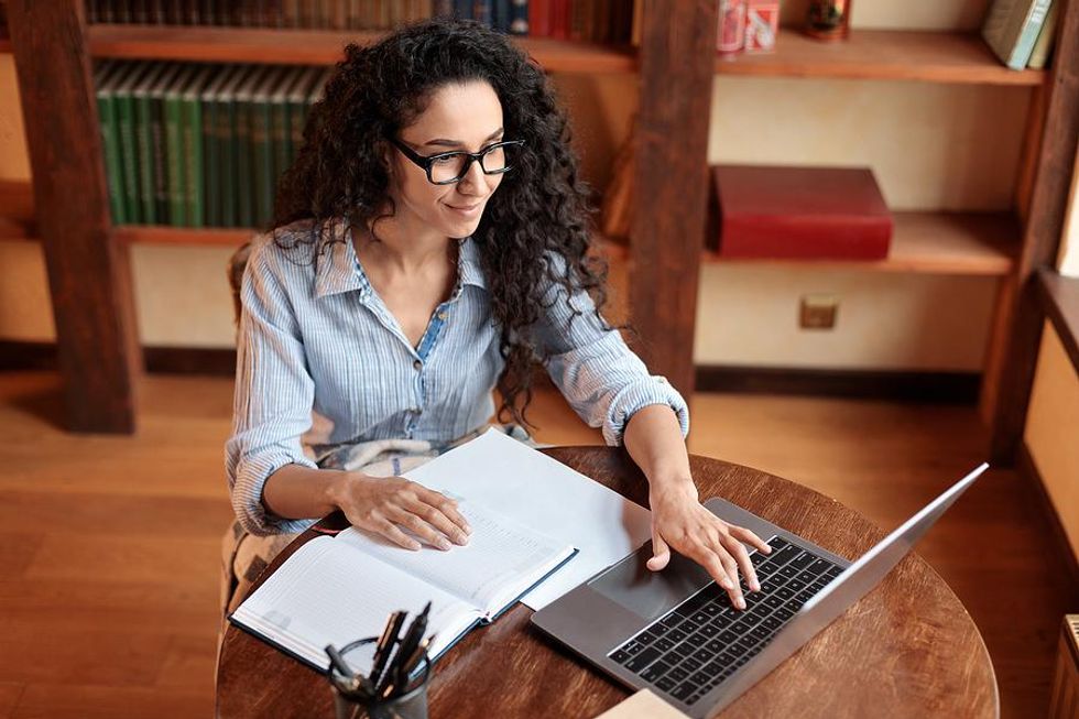 Woman on laptop works on her resume