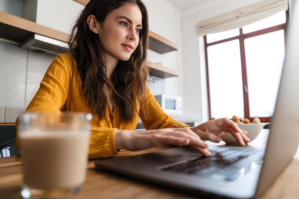 Woman on laptop adds a few things to her resume