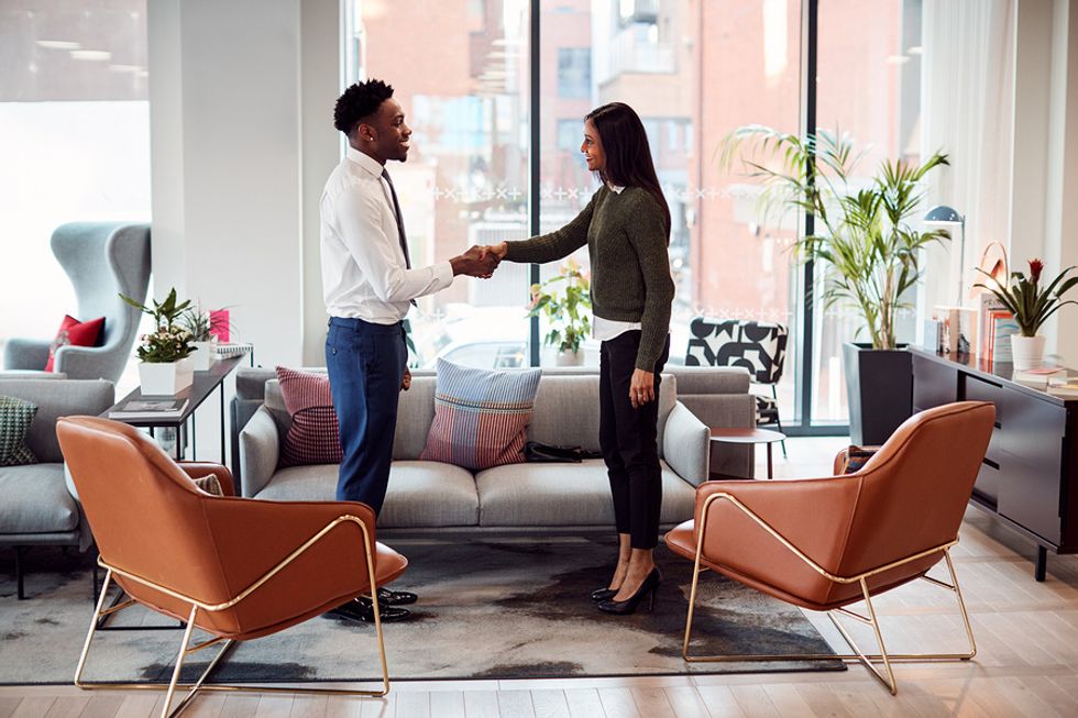 Job candidate shakes the hiring manager's hand before a job interview