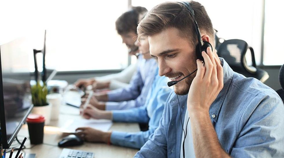 Man in call center talks to a customer
