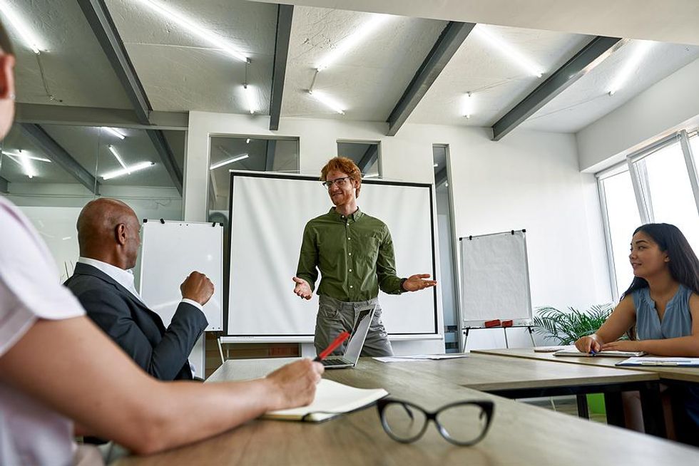 Leader talks to his team members during a work meeting