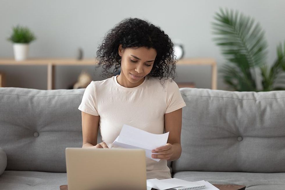 Woman on laptop reads a letter of feedback from a hiring manager