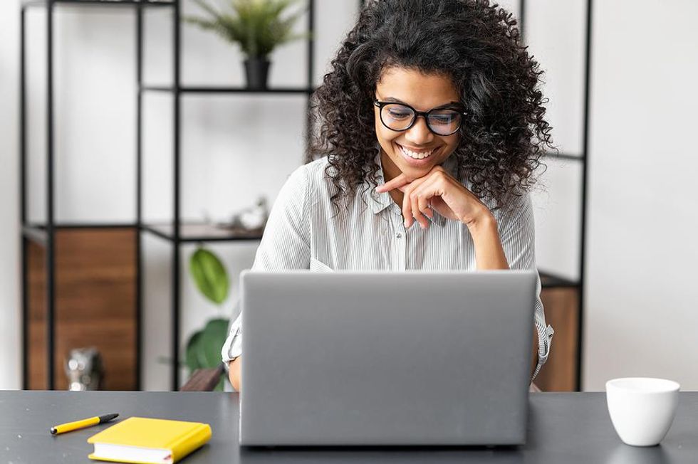 Woman on laptop writes a resume for her career change