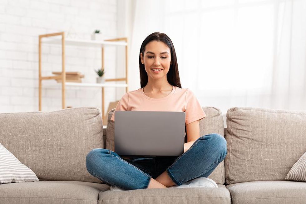 Woman on laptop writes the most important part of her resume