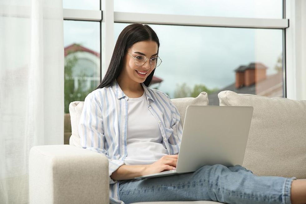 Woman on laptop condenses her resume