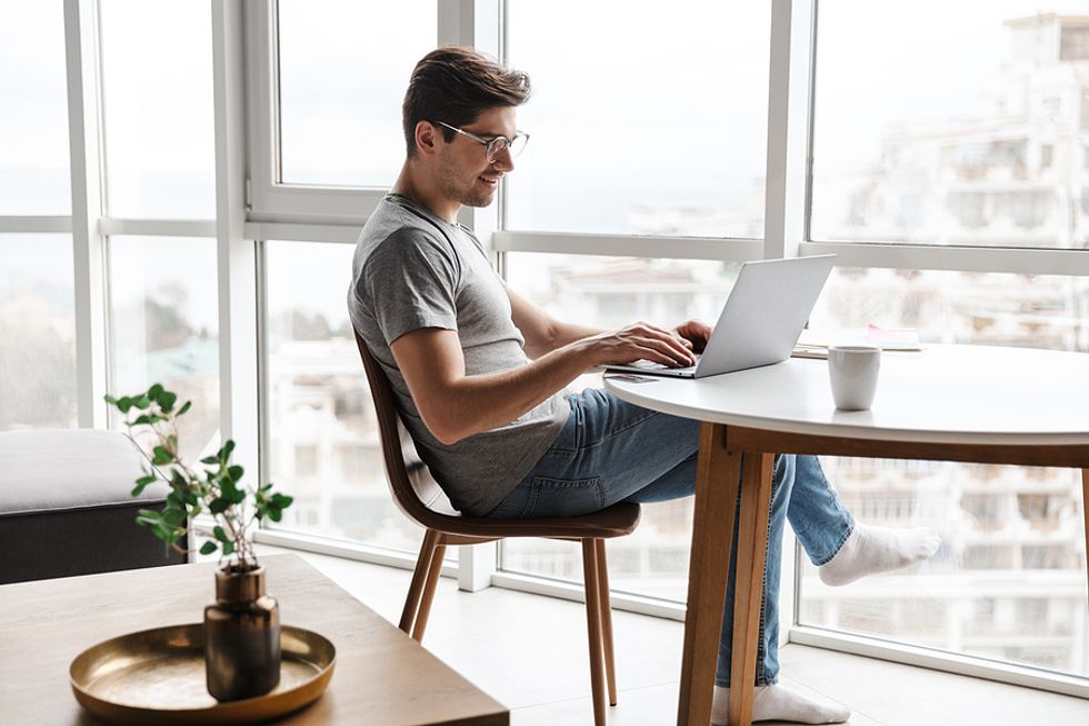 Man on laptop writes a cover letter for a job opening