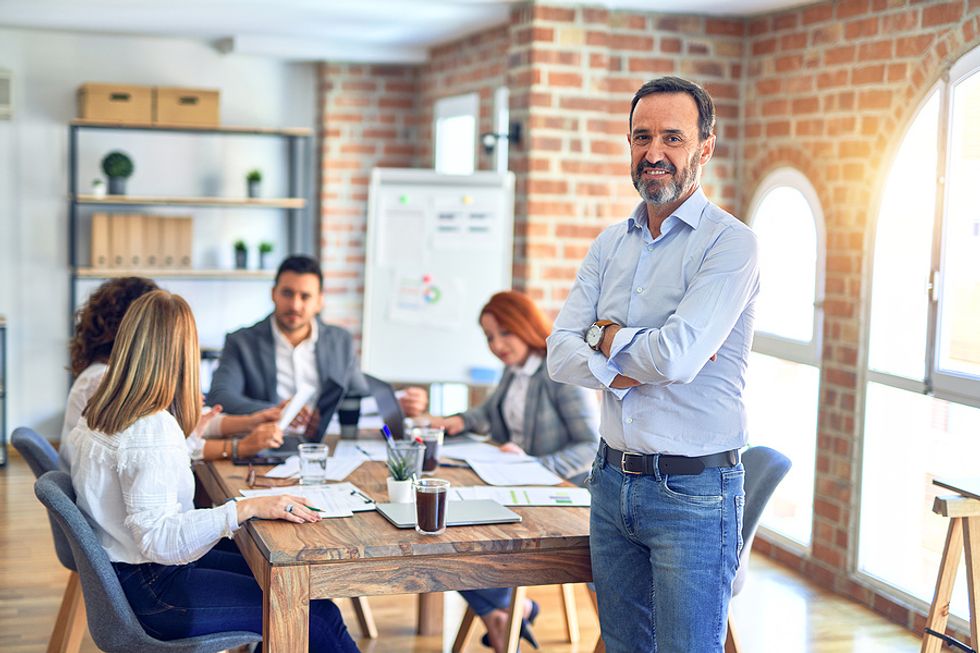 Professional man working in a casual environment attends a meeting