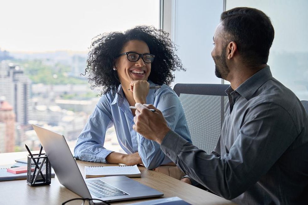 Coworkers talk to each other in the office