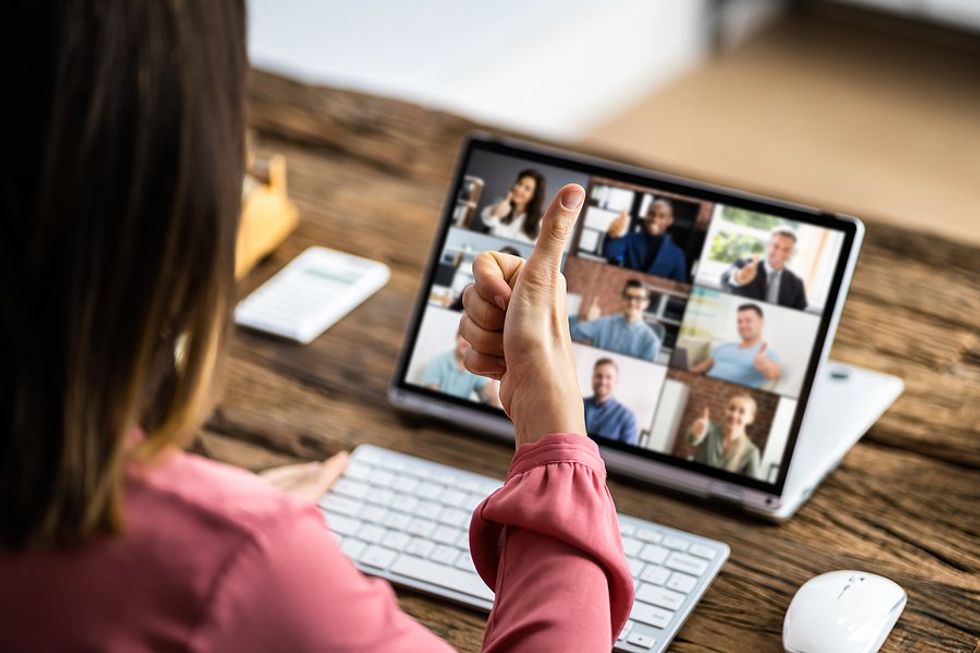Woman working remotely for a hybrid company attends a virtual meeting