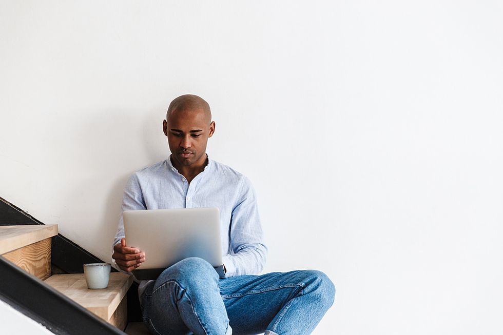 Man on laptop adds more information to his LinkedIn profile