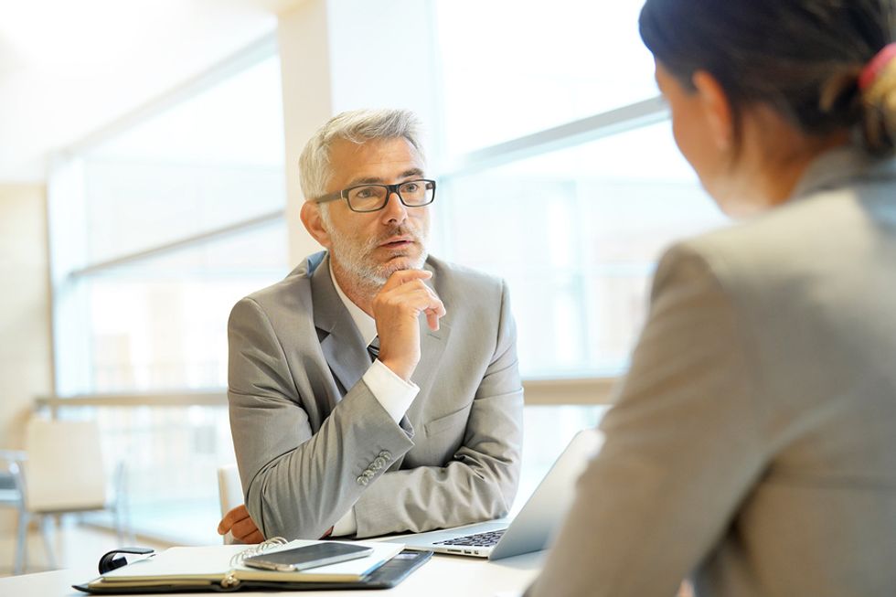 A leader demonstrates his good listening skills while talking to a coworker