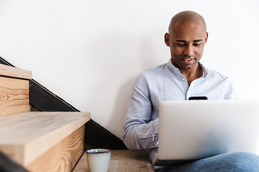 Man on laptop learns new skills before returning to the workforce