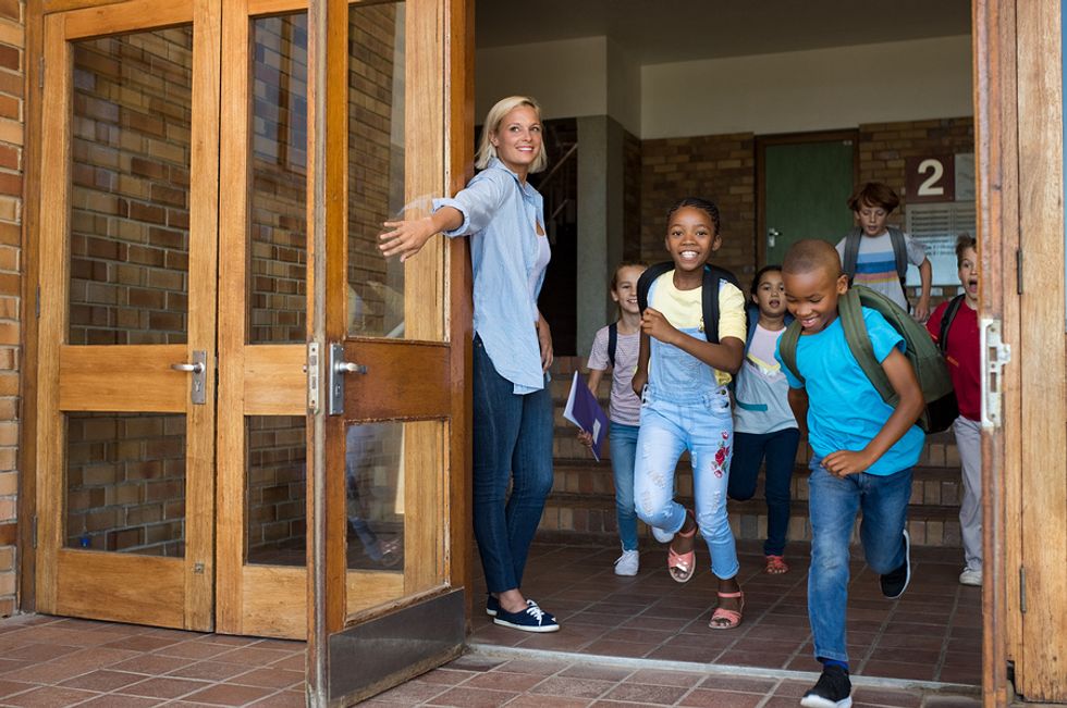 Teacher opens the door for her summer school students