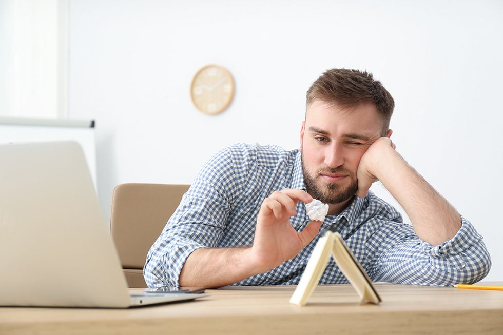 A disinterested/bored employee wastes time at work